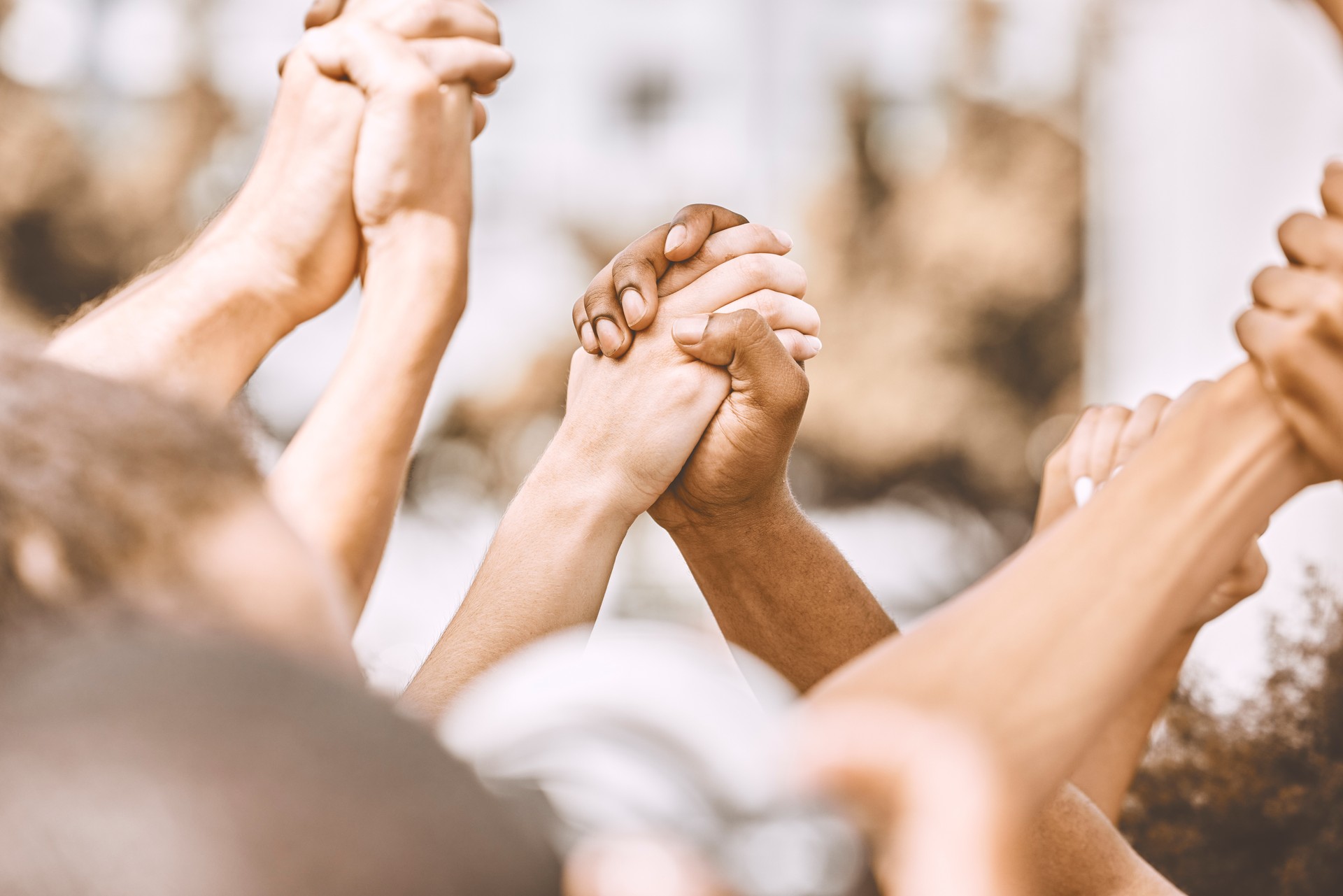 Prayer, hands and people in support of worship, god and religion while holding hands and bonding outdoors. Community, peace and praying by friends with diversity, love and spiritual praise together