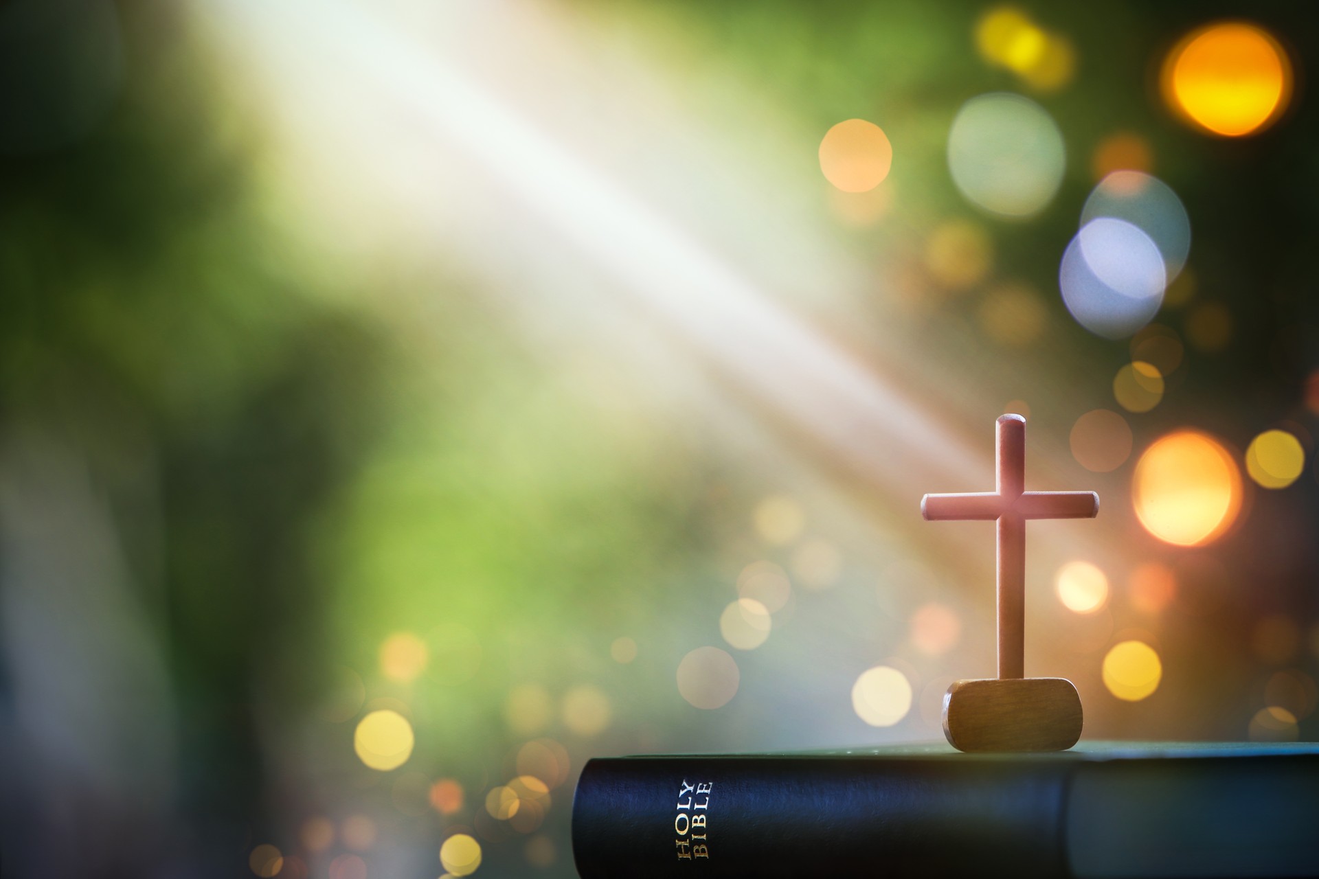 Bright light and bible and the cross of Jesus Christ and light bokeh